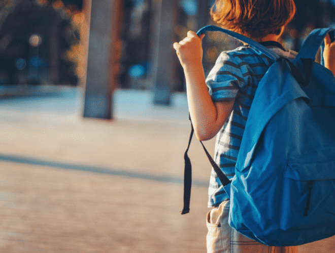 A student carrying a blue backpack ready for school, illustrating back to school tips with Easytrip.
