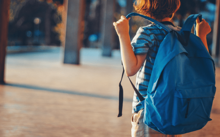 A student carrying a blue backpack ready for school, illustrating back to school tips with Easytrip.