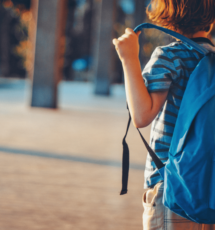 A student carrying a blue backpack ready for school, illustrating back to school tips with Easytrip.
