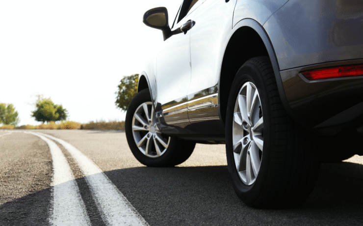 A silver car on an open road — reminder to update your car registration on Easytrip to avoid toll charges.