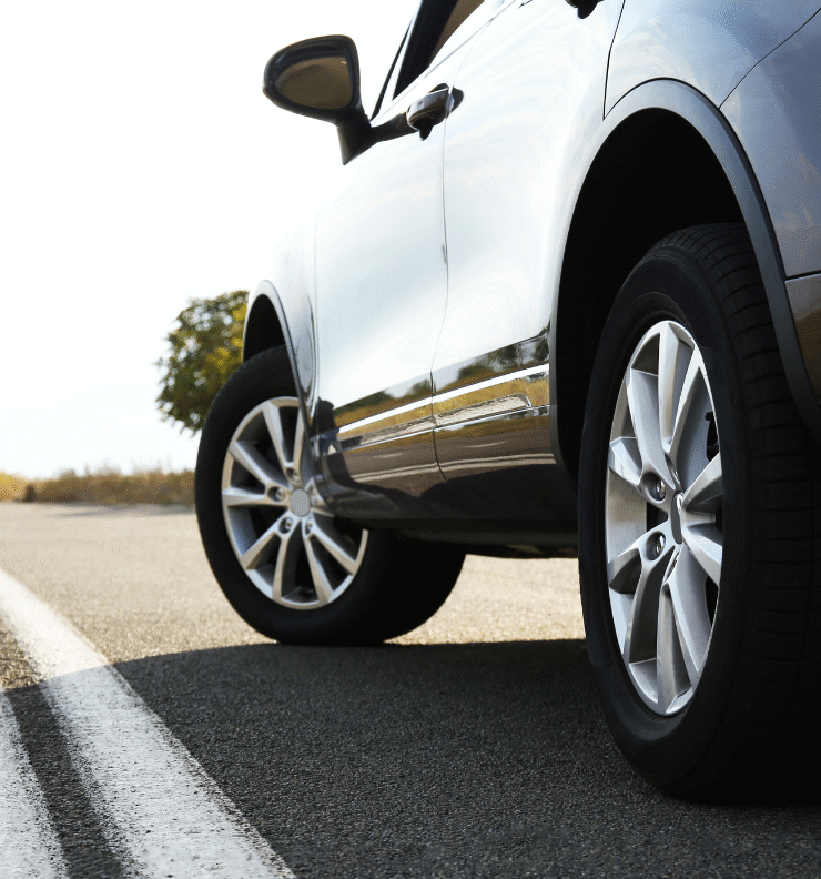 A silver car on an open road — reminder to update your car registration on Easytrip to avoid toll charges.