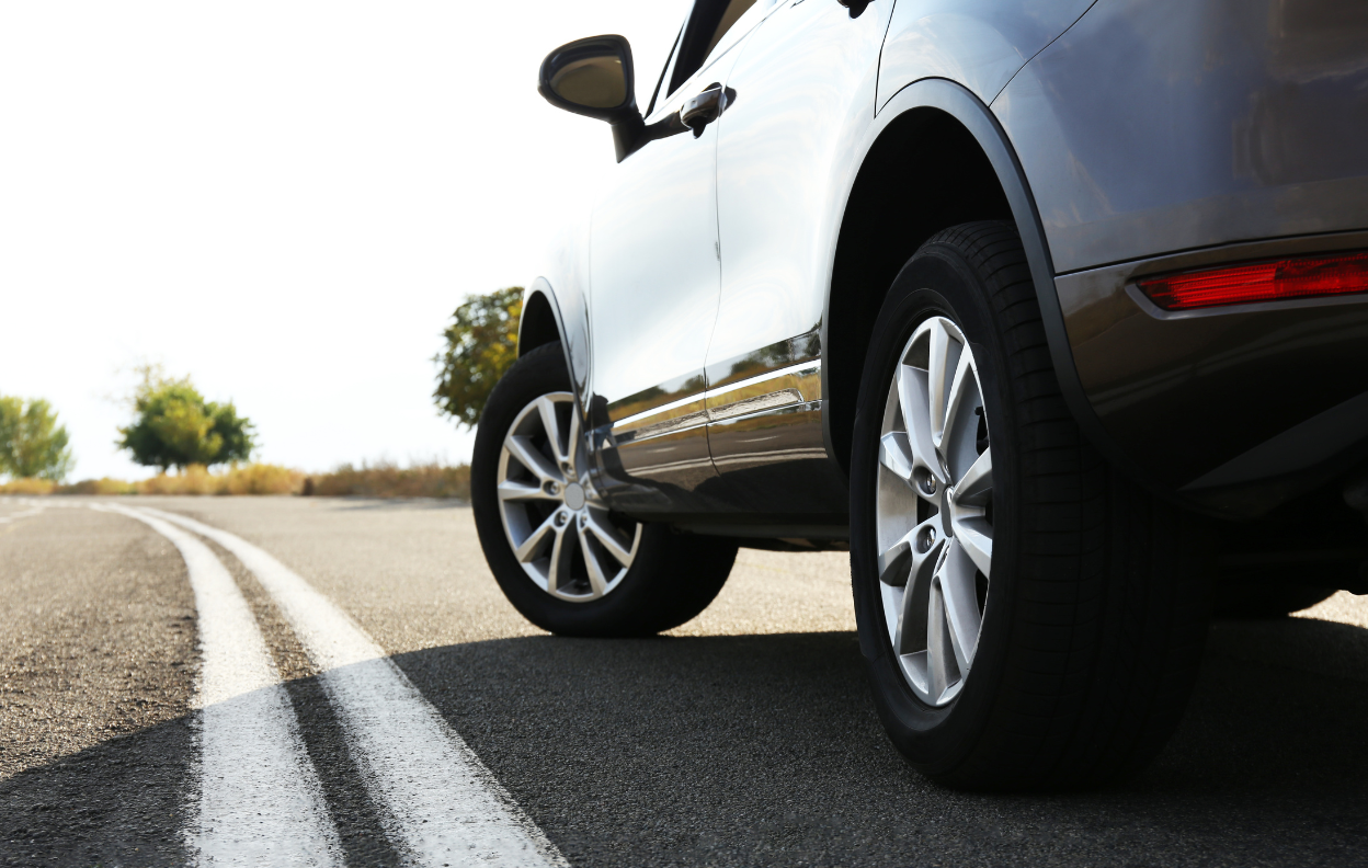 A silver car on an open road — reminder to update your car registration on Easytrip to avoid toll charges.