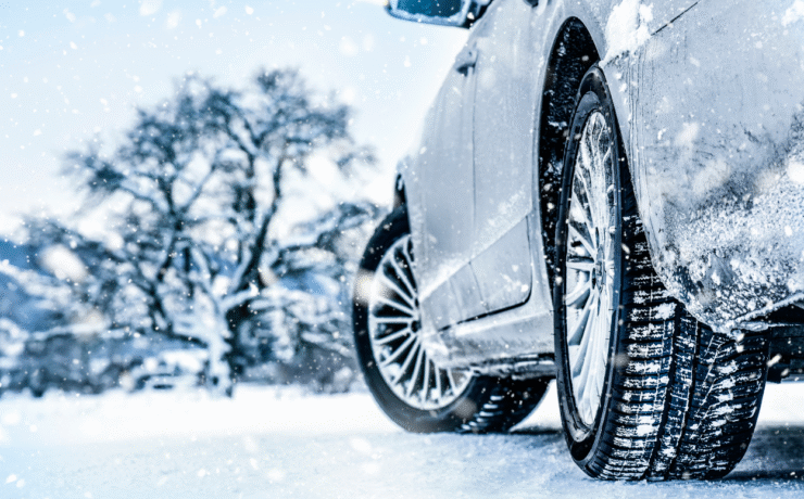 A close-up of a car tyre driving on a snowy Irish road, representing Easytrip’s tips to get your car winter ready for safe driving in cold weather.