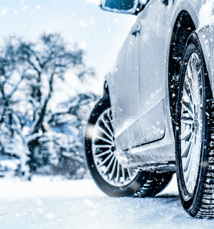 A close-up of a car tyre driving on a snowy Irish road, representing Easytrip’s tips to get your car winter ready for safe driving in cold weather.
