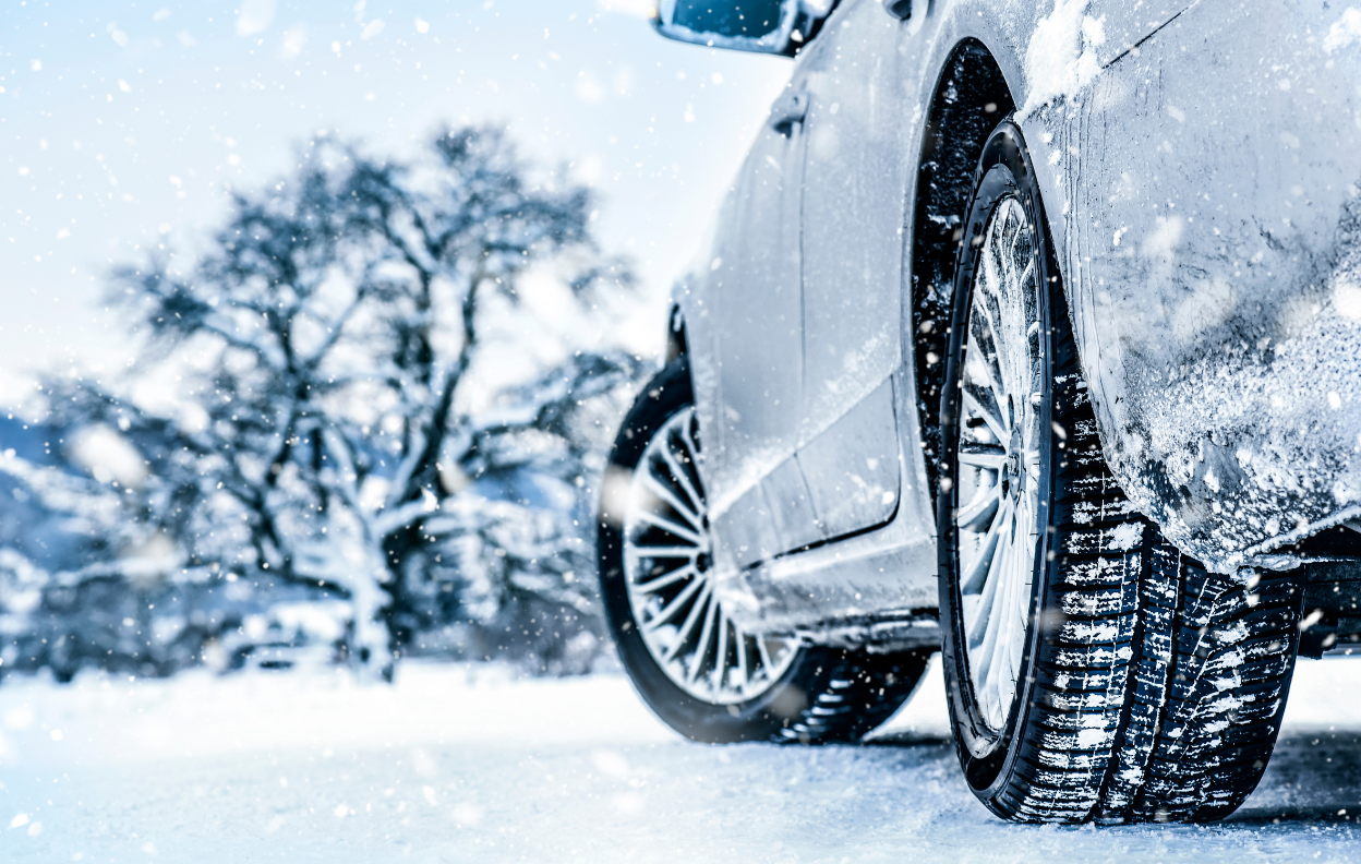 A close-up of a car tyre driving on a snowy Irish road, representing Easytrip’s tips to get your car winter ready for safe driving in cold weather.