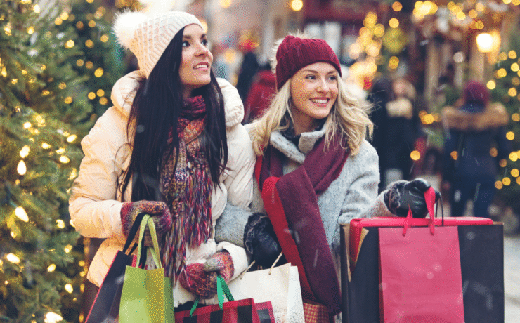 Two women Christmas shopping on a festive street with lights and trees in Dublin – ideal for Dublin Christmas Parking 2025