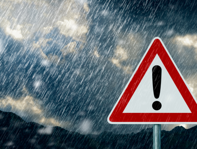 Car driving in heavy rain showing the challenges of driving in bad weather in Ireland