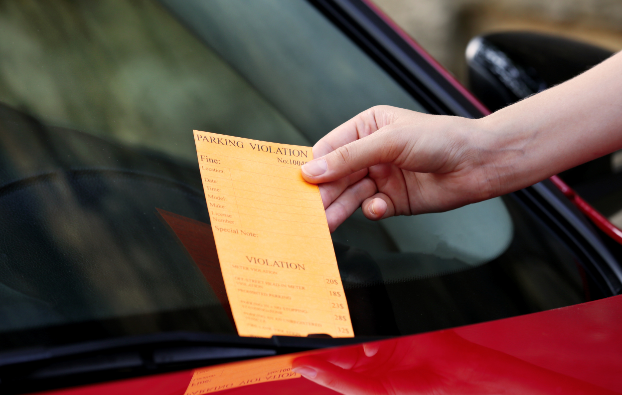 Parking charge notice on a car windscreen showing what happens if you forget to pay for parking