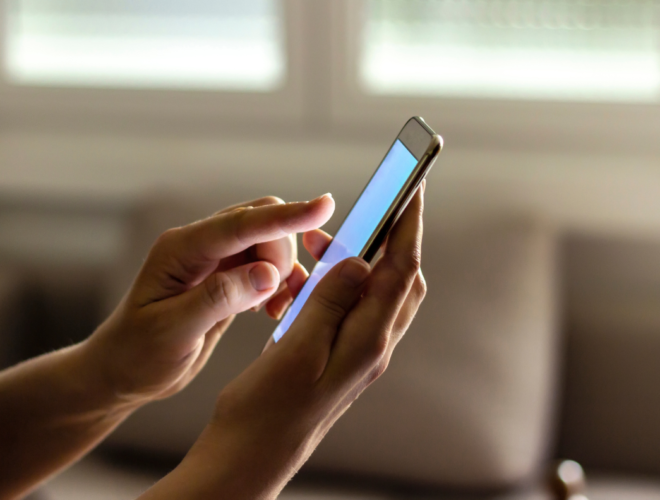 Person updating car registration Easytrip details online using a mobile phone