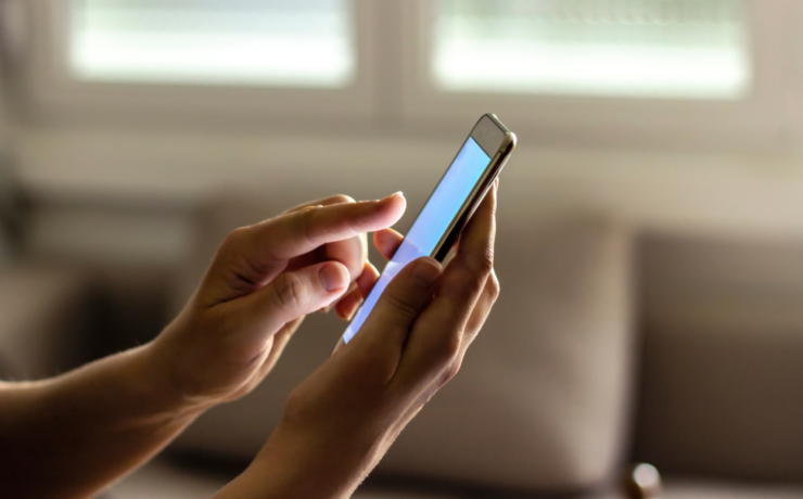 Person updating car registration Easytrip details online using a mobile phone