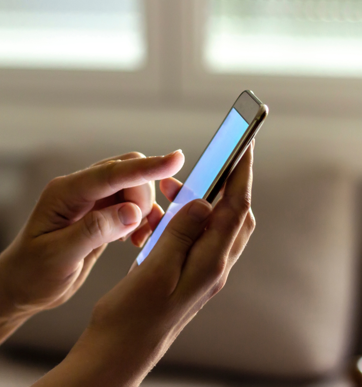 Person updating car registration Easytrip details online using a mobile phone