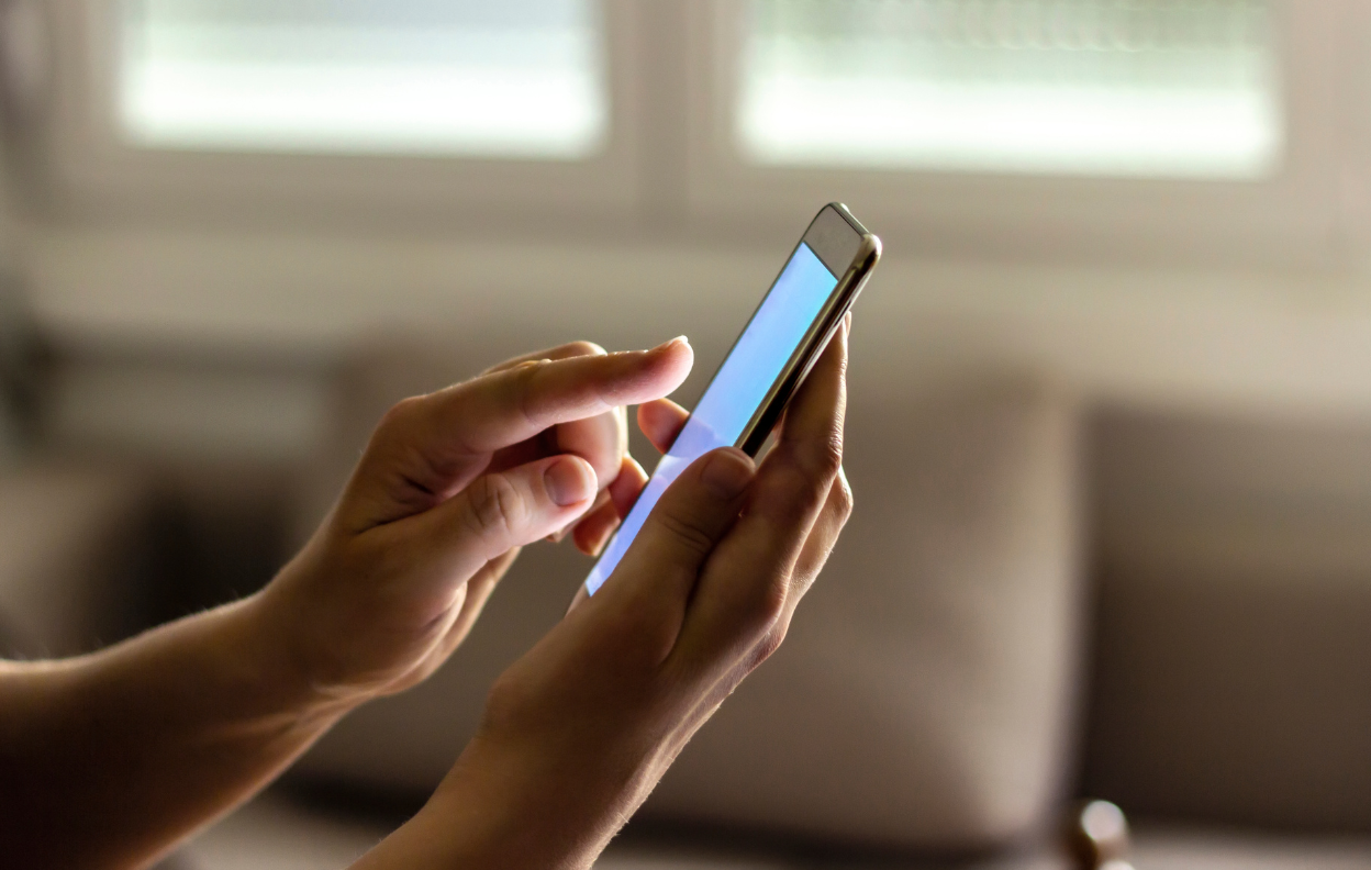 Person updating car registration Easytrip details online using a mobile phone